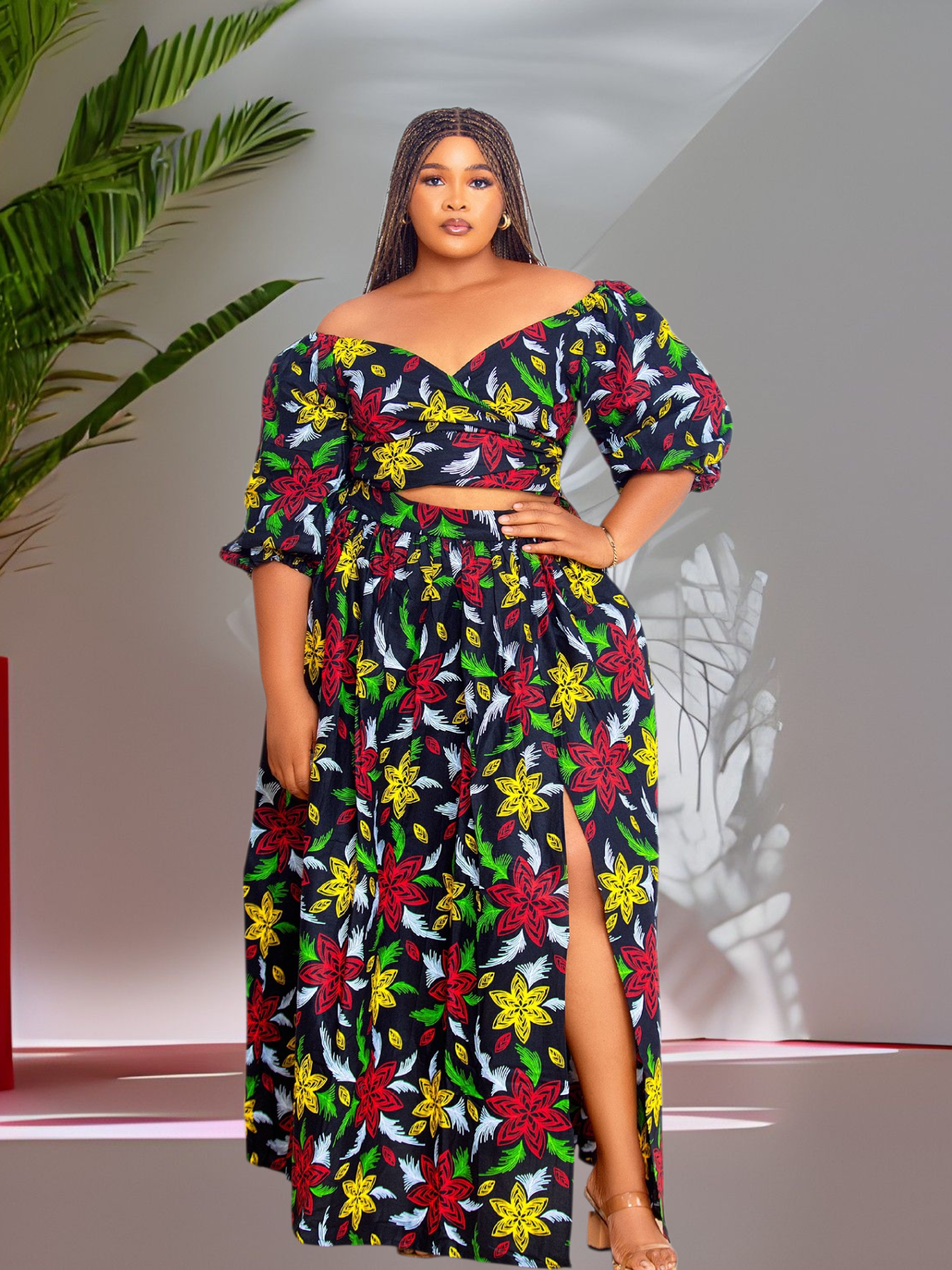 Woman wearing a colorful floral wrap top and maxi skirt dress set against a neutral background