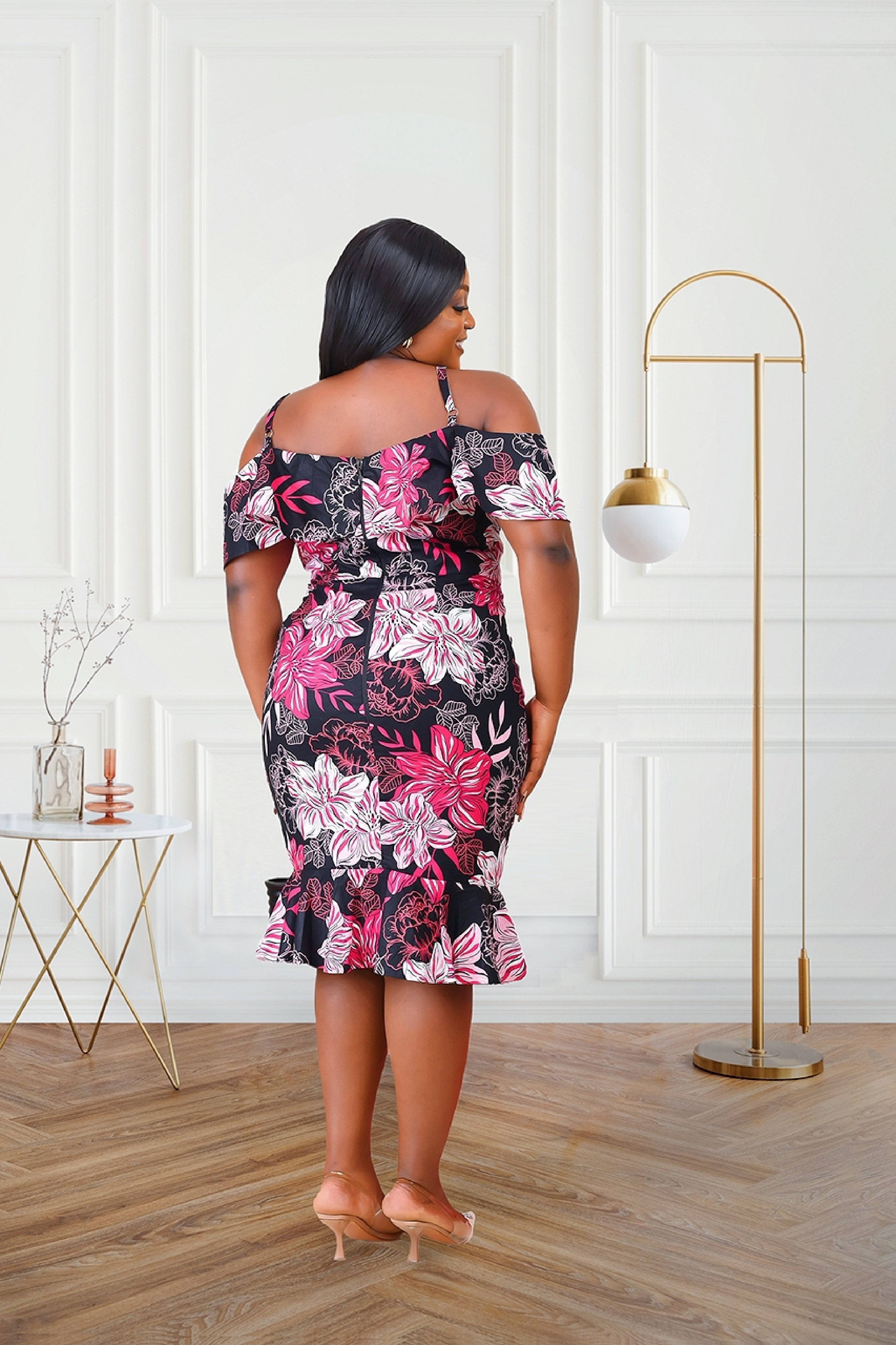 Woman in an African print cold shoulder multicolored red black pink midi dress outfit