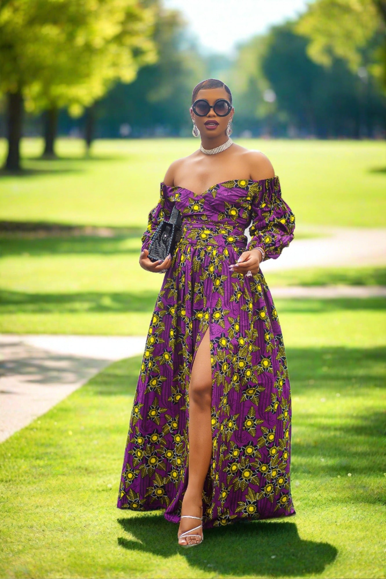 A woman wearing a bold African print Ankara purple and yellow African print wrap top with bubble sleeves and a off-the-shoulder neckline.